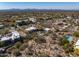 Aerial view showcasing a desert home with mountain views, neighboring houses, and desert landscape at 9370 E Calle De Las Brisas --, Scottsdale, AZ 85255