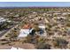 Aerial view showcasing desert home with mountain views, neighboring houses, and desert landscape at 9370 E Calle De Las Brisas --, Scottsdale, AZ 85255