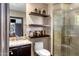 Stylish bathroom with a glass shower enclosure, floating shelves, and modern fixtures at 9370 E Calle De Las Brisas --, Scottsdale, AZ 85255