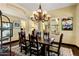 Elegant dining room with a decorative chandelier, hardwood floors, and sophisticated decor at 9370 E Calle De Las Brisas --, Scottsdale, AZ 85255