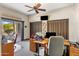 Bright home office featuring outdoor access, a ceiling fan, and ample desk space at 9370 E Calle De Las Brisas --, Scottsdale, AZ 85255