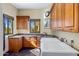 Functional laundry room with granite counters, wood cabinets and lots of natural light at 9370 E Calle De Las Brisas --, Scottsdale, AZ 85255