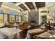 Inviting living room with a stone fireplace, hardwood floors, and natural light from large windows at 9370 E Calle De Las Brisas --, Scottsdale, AZ 85255