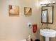 Chic powder room featuring a pedestal sink, decorative sconces, and artwork at 9370 E Calle De Las Brisas --, Scottsdale, AZ 85255