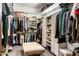 Spacious walk-in closet features custom shelving, hanging rods, and a central ottoman at 9370 E Calle De Las Brisas --, Scottsdale, AZ 85255