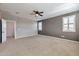 Carpeted bedroom featuring a ceiling fan, three windows, and neutral walls at 9743 E Torino Ave, Mesa, AZ 85212