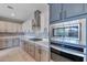 Modern kitchen with stainless steel appliances, white and gray cabinets, countertops, and tiled backsplash at 9743 E Torino Ave, Mesa, AZ 85212