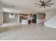 Open living room featuring tiled floors, ceiling fan, and open view of the modern kitchen with center island at 9743 E Torino Ave, Mesa, AZ 85212