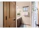 A full guest bathroom featuring wood cabinetry and a shower with a leafy curtain at 987 S Phelps Dr, Apache Junction, AZ 85120