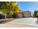 Charming single-story home featuring a three-car garage and desert landscaping at 987 S Phelps Dr, Apache Junction, AZ 85120