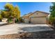 Charming single-story home featuring a three-car garage and desert landscaping at 987 S Phelps Dr, Apache Junction, AZ 85120