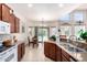 Well-lit kitchen with stainless sink, granite counters, and breakfast nook with outdoor access to the pool at 987 S Phelps Dr, Apache Junction, AZ 85120