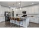 Modern kitchen with white cabinetry, granite countertops, stainless steel appliances, and a center island at 10136 E Sphere Ave, Mesa, AZ 85212