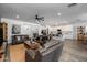 Open-concept living area with modern decor flowing into the kitchen and staircase at 10136 E Sphere Ave, Mesa, AZ 85212