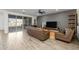 Modern living room with sleek gray walls, wood-look floors, and access to a covered patio at 10136 E Sphere Ave, Mesa, AZ 85212