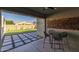 The covered patio offers a stunning view of the beautifully landscaped backyard at 10136 E Sphere Ave, Mesa, AZ 85212