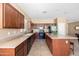 Well-lit kitchen featuring an island with bar stool seating and dark cabinets at 1044 E Stottler Ct, Gilbert, AZ 85296