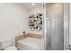 Bathroom showcasing tub with tiled walls, and modern decorative wall art at 10757 N 74Th St # 1016, Scottsdale, AZ 85260