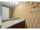 Stylish powder room with unique wallpaper, decorative mirror, and elegant vanity at 10757 N 74Th St # 1016, Scottsdale, AZ 85260