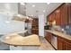 Well-equipped kitchen with stainless steel appliances, granite counters, and a stylish vent hood at 10757 N 74Th St # 1016, Scottsdale, AZ 85260