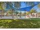 A community pool with blue shade coverings, ample seating, and well-maintained green space at 10757 N 74Th St # 1016, Scottsdale, AZ 85260