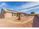 Spacious backyard featuring desert landscaping, a covered patio, and ample room for outdoor activities at 1153 W 12Th Ave, Apache Junction, AZ 85120