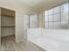 Bright bathroom showcasing a glass-enclosed shower, soaking tub, and natural light at 13223 W Indianola Ave, Litchfield Park, AZ 85340