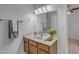 A bathroom vanity with wood cabinets, a mirror, and decor at 137 W Gary Way, Gilbert, AZ 85233