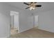 A well-lit bedroom featuring a ceiling fan and wood-look flooring at 137 W Gary Way, Gilbert, AZ 85233