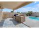 Outdoor kitchen area by pool with built in BBQ under a covered patio in a private backyard at 137 W Gary Way, Gilbert, AZ 85233