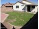 The backyard showcases a partially green lawn, patio cover, and potential for landscaping at 13819 W Berridge Ln, Litchfield Park, AZ 85340