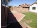 A large patio area is ready for outdoor gatherings within the yard, bordered by block walls at 13819 W Berridge Ln, Litchfield Park, AZ 85340