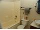 Bathroom featuring a standard tub and shower combination, with neutral tile and a simple vanity at 13819 W Berridge Ln, Litchfield Park, AZ 85340