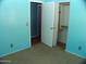 Blue bedroom featuring closet and entry door at 13819 W Berridge Ln, Litchfield Park, AZ 85340