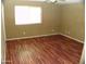 Spacious bedroom featuring hardwood floors and a bright window at 13819 W Berridge Ln, Litchfield Park, AZ 85340