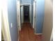 Hallway with a wood floor and neutral walls, and multiple rooms leading off from it at 13819 W Berridge Ln, Litchfield Park, AZ 85340