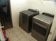 Well-lit laundry room featuring a modern washer and dryer set for efficient chore management at 13819 W Berridge Ln, Litchfield Park, AZ 85340