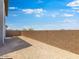 Fenced backyard with dirt, a brick wall and a view of clear blue skies at 14634 W Sand Hills Rd, Surprise, AZ 85387