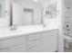 Bathroom featuring dual sinks, a large mirror, and toilet with tub and shower at 14634 W Sand Hills Rd, Surprise, AZ 85387