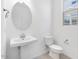 Elegant half bathroom with pedestal sink and modern fixtures at 14634 W Sand Hills Rd, Surprise, AZ 85387