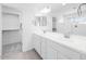 Bright bathroom featuring double sinks, walk in closet, and modern fixtures at 14634 W Sand Hills Rd, Surprise, AZ 85387