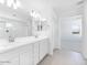 Modern bathroom with dual sinks, a large mirror, and white cabinets at 14634 W Sand Hills Rd, Surprise, AZ 85387