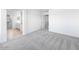 Bedroom with neutral carpet and ensuite bathroom featuring tile flooring at 14634 W Sand Hills Rd, Surprise, AZ 85387