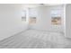 Bright, airy bedroom with three large windows and neutral carpet at 14634 W Sand Hills Rd, Surprise, AZ 85387