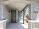 Inviting entryway featuring arched openings, brick columns, and a stylish gray front door with sidelight at 14634 W Sand Hills Rd, Surprise, AZ 85387