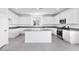 Bright kitchen features white cabinets, granite countertops, stainless steel appliances, and center island at 14634 W Sand Hills Rd, Surprise, AZ 85387
