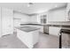 Bright kitchen featuring white cabinets, granite countertops, stainless steel appliances, and center island at 14634 W Sand Hills Rd, Surprise, AZ 85387