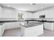 Bright kitchen features white cabinets, granite countertops, stainless steel appliances, and center island at 14634 W Sand Hills Rd, Surprise, AZ 85387