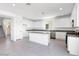 Bright kitchen featuring white cabinets, granite countertops, stainless steel appliances, and center island at 14634 W Sand Hills Rd, Surprise, AZ 85387