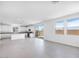 Open concept living space with kitchen and island, seamlessly flowing into a sunlit living area at 14634 W Sand Hills Rd, Surprise, AZ 85387